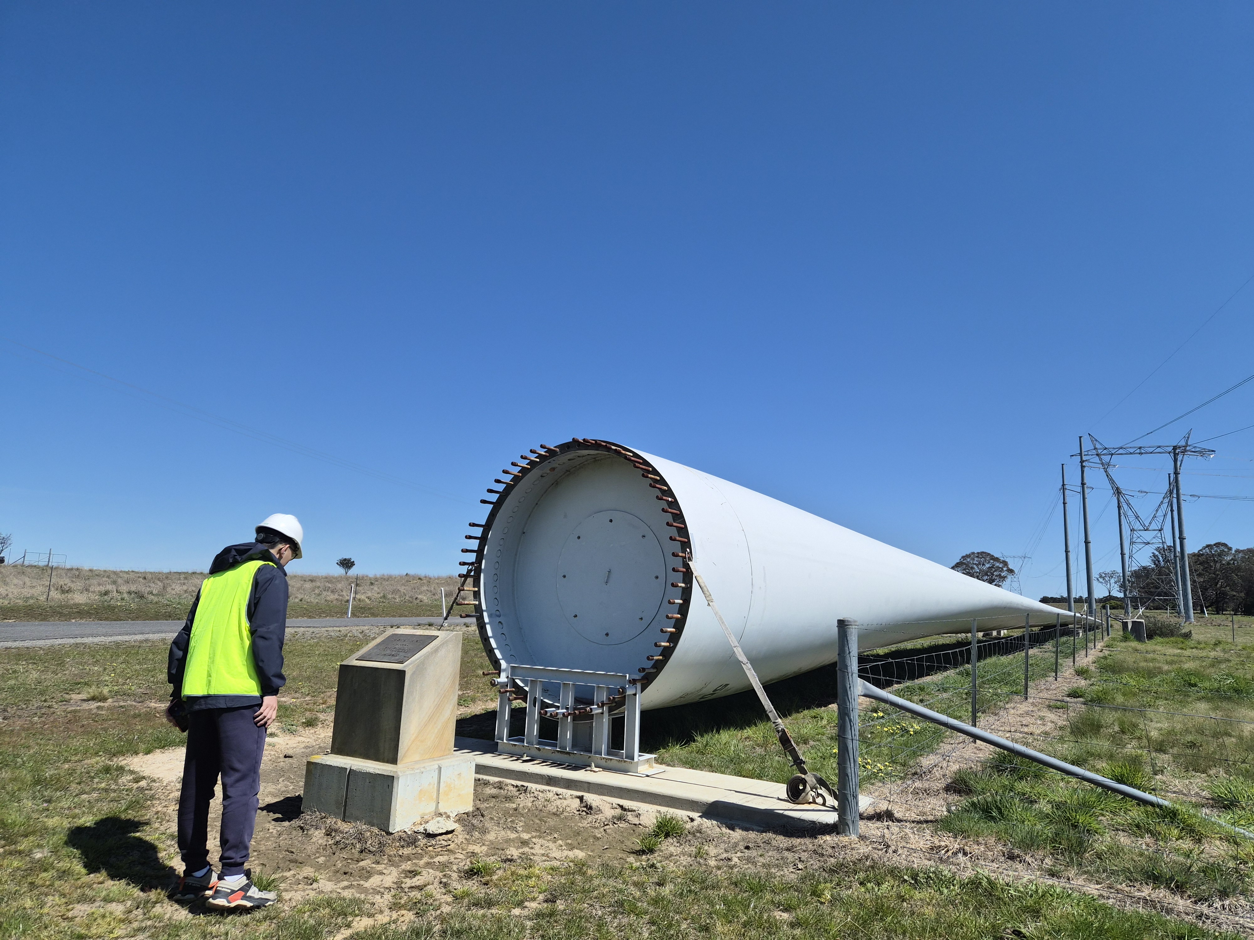 Student looking at a decommissioned wind turbine (photo credit: Weiting Sun and Nara Choi)