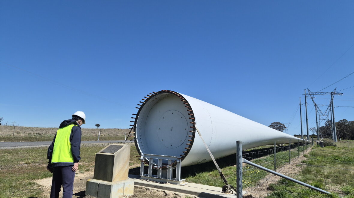 Student looking at a decommissioned wind turbine (photo credit: Weiting Sun and Nara Choi)