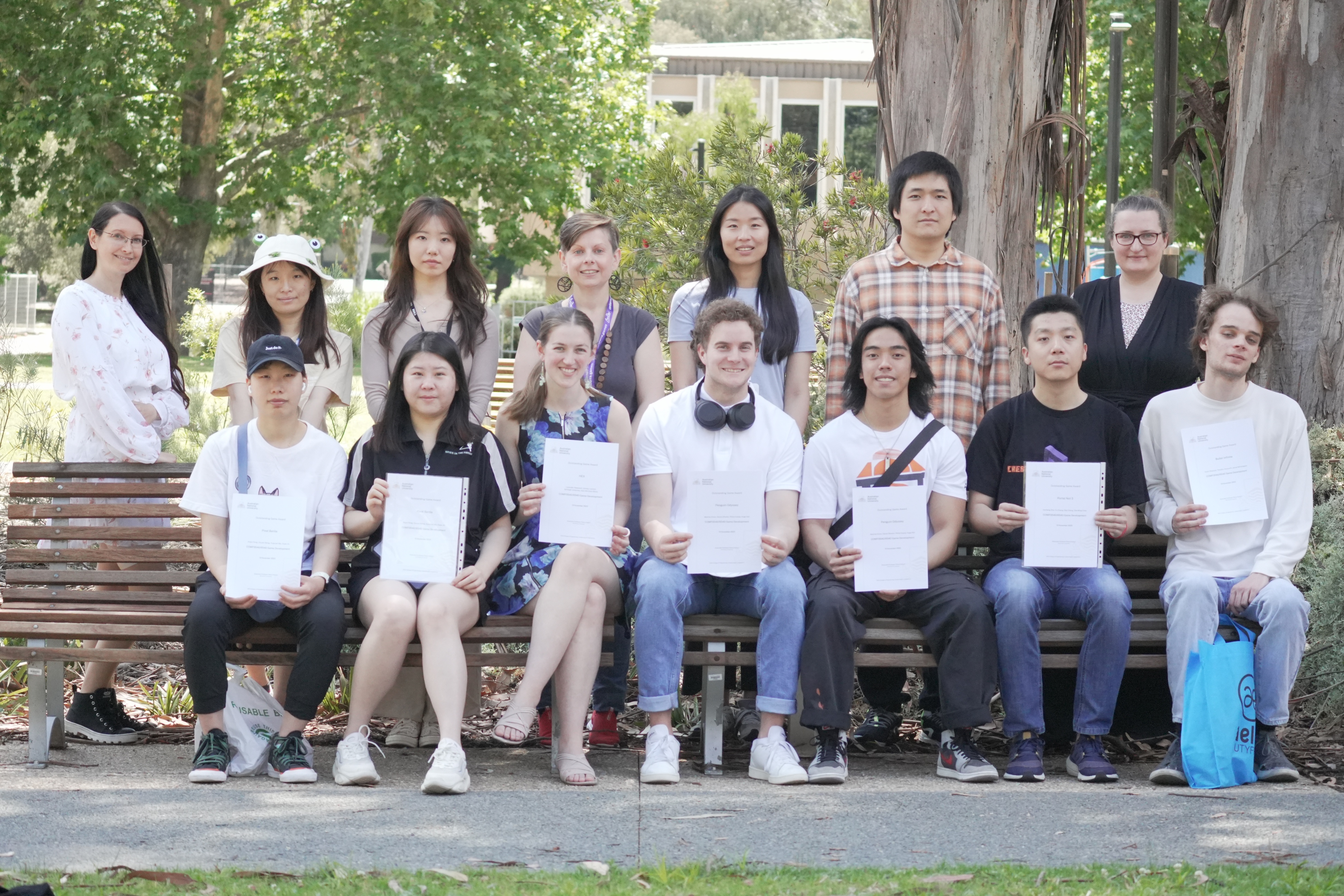 Associate Professor Penny Kyburz (centre back) with Game Development top game award recipients (front row) and course tutors (back row).
